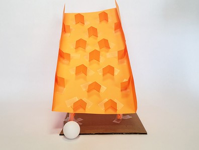 A 'plinko' style ball run built from paper and tape