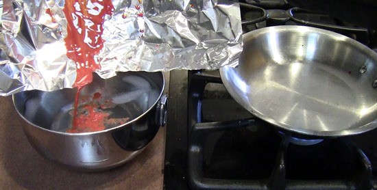 Melted crayons being poured into a bowl of ice water.