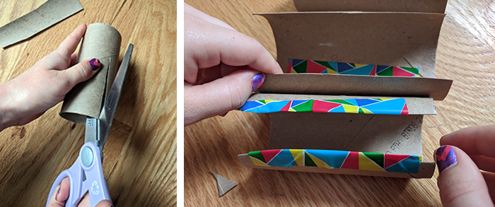 Student cutting and taping cardboard tubes as part of a homemade marble run