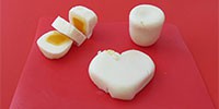 Hard-boiled eggs shaped as a cylinder, heart, and cut up rectangle