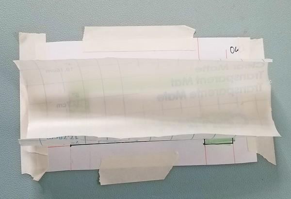 Checking to see if the Con-Tact paper cut out is slightly larger than the template shape. 
