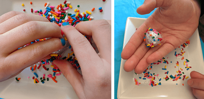 Student rolling aluminum foil virus models in candy sprinkles