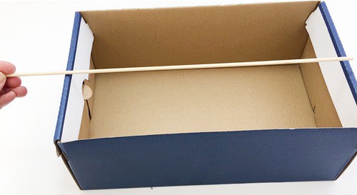 Shoebox with a skewer that is longer than the box's length.