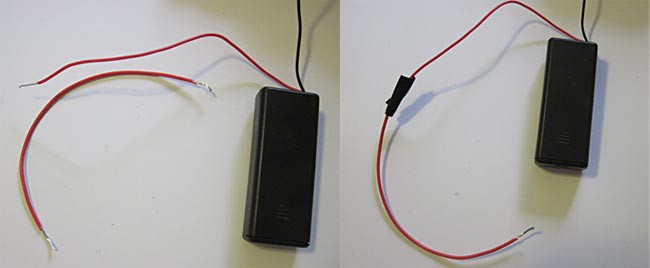 Electrical tape connects a red wire to the positive lead of a battery pack