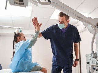 high five doctor and child patient