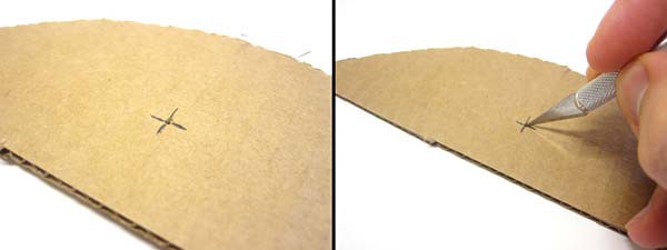 Slits are made at the focal point of a parabola cut from cardboard