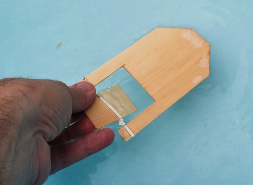Rubber band paddle boat in a kiddie pool