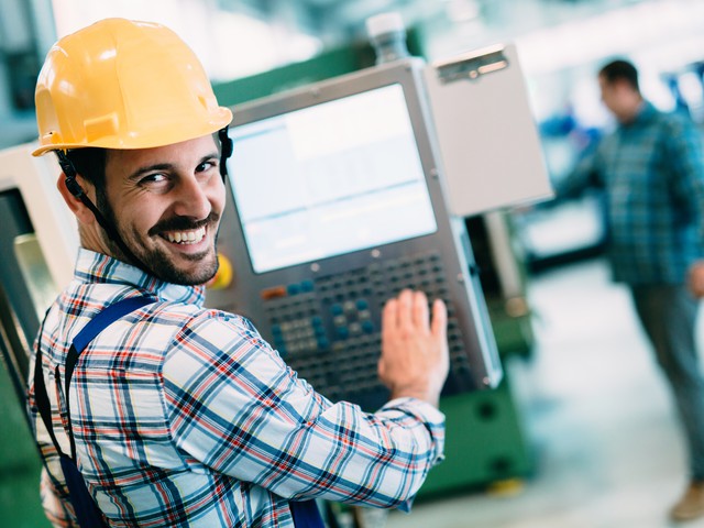 Industrial factory employee working in metal manufacturing industry