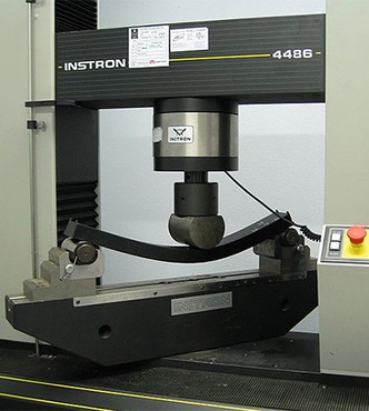 The right images shows how a beam is bent inside a machine by applying pressure to its center.