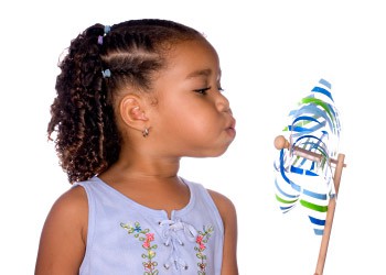 A child blows on a pinwheel