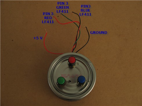 A red, blue and green knob protrude from the underside of an aluminum can