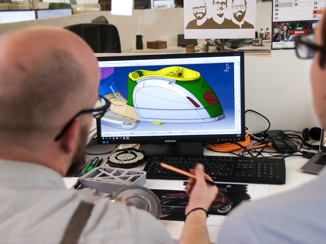 person looking at CAD design of scooter on screen