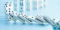 How fast a row of dominoes topples depends on friction