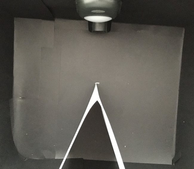  Top view of the opened-up test box. The V shape stands in the box with point of the V facing the light.   