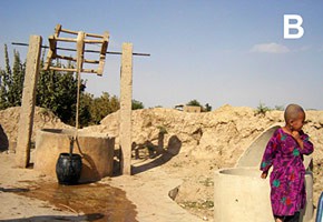 A child standing next to a water well