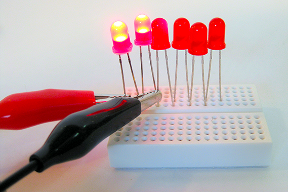 Breadboard with multiple LEDs, part of a human-powered, shake it up, generator