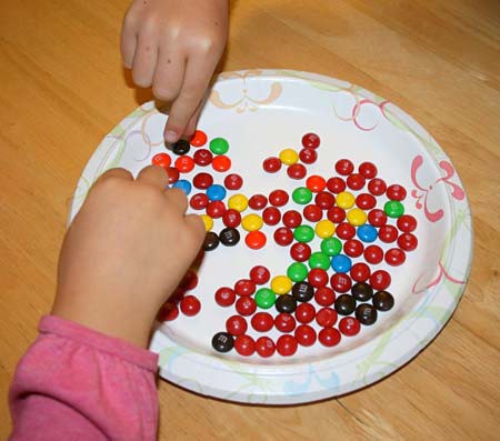Hands grabbing candy from a plate