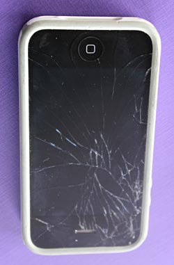Photo of an iPhone with a cracked screen