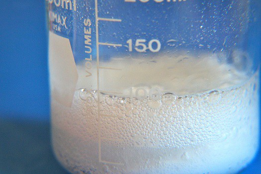 Baking soda and vinegar mixed together and bubbling in a beaker