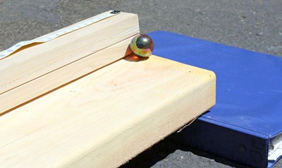 A marble rests on an inclined plane