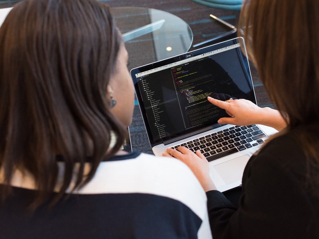 women looking at code