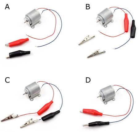 Alligator clips are attached to the ends of wires from a motor