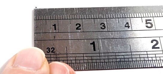 A pencil dot is measured with a ruler.