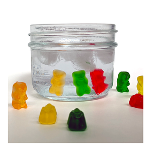 Jar of gummy candies in water that have grown larger than the gummies outside the water - Willy Wonnka-inspired Make-Believe STEM Science Experiments