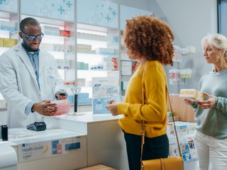 pharmacist answering questions helping customers