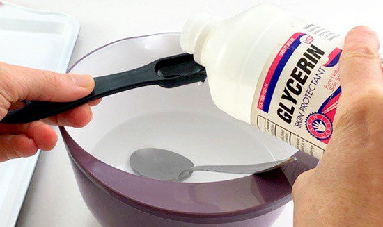 A tablespoon of glycerin being added to a clear solution