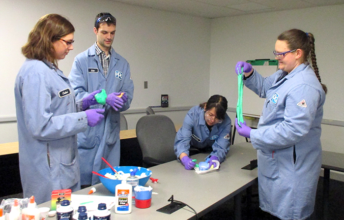 Four volunteers from PPG Industries make homemade slime