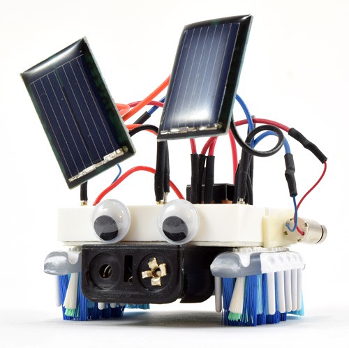 A small bristlebot has two small solar panels mounted above its body