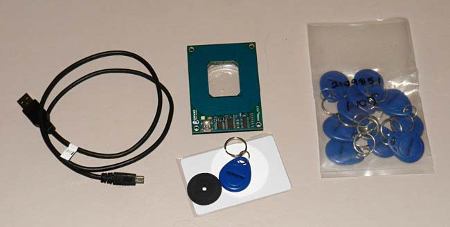 A USB cable, RFID reader and a bag of RFID tags