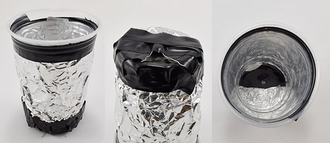 A photoresistor is inserted into the bottom of a clear plastic cup that has been completely covered by aluminum foil
