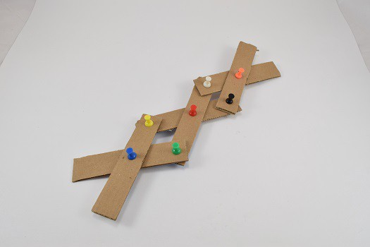 Strips of cardboard pinned together with push pins