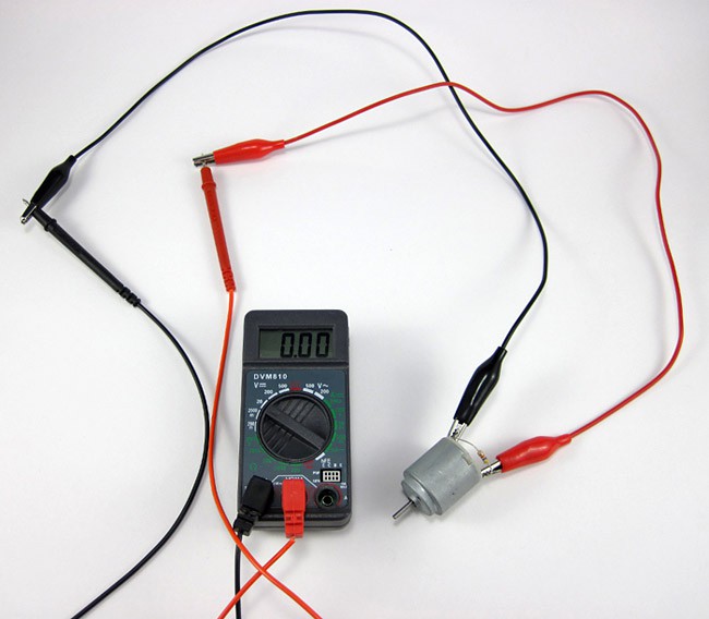 Alligator clips attach a motor to probes on a multimeter
