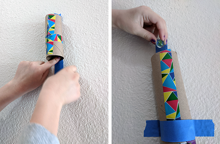 Two images showing taping cardboard tubes to the wall for the marble run and dropping a marble in to test