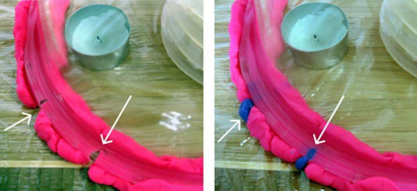 Cracks forming in play-doh that is used to seal an upside-down glass bowl to a table are repaired with blue play-doh