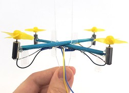 drone mounted on two strings which are pulled taut at the bottom 