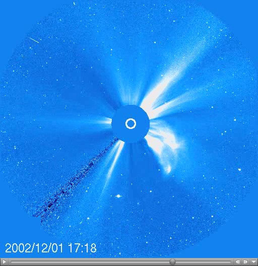 A coronagraph shows a large white flare emerging from the surface of the Sun with a timestamp of 2002/12/01 17:18