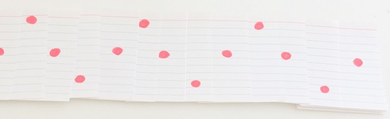 Stack of partially overlapping cards. One red dot is visible in each card. The dots on consecutive cards are on the top,  middle, bottom, middle, top, ...