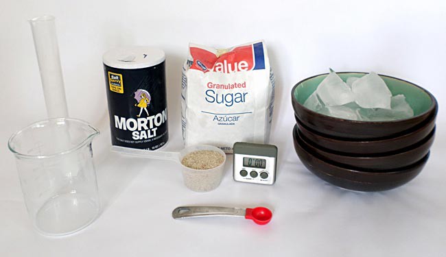 Household materials along with one tablespoon of sand needed to perform the ice melting experiment