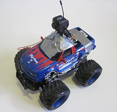 A camera duct taped to the top of a remote controlled toy monster truck