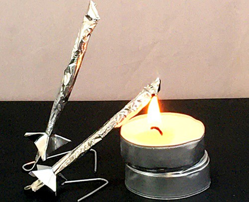  Two matchstick rockets, both have fins near the bottom of the rockets.  