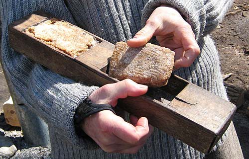 A large brown maple sugar cube