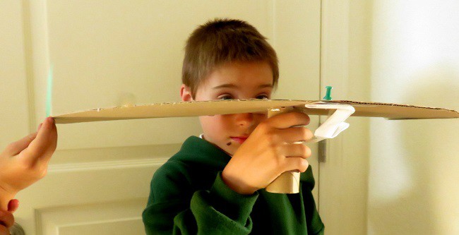 A child testing his peripheral vision using the device he created in this activity.
