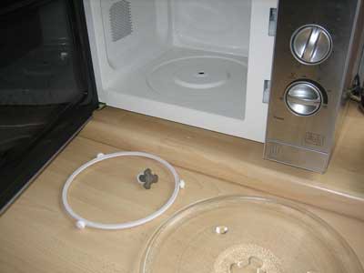 The turntable and drive mechanism in a microwave are removed