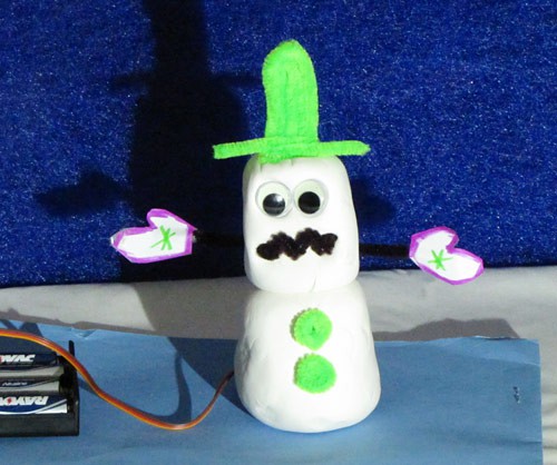 Photo of a model clay snowman wired to a battery pack