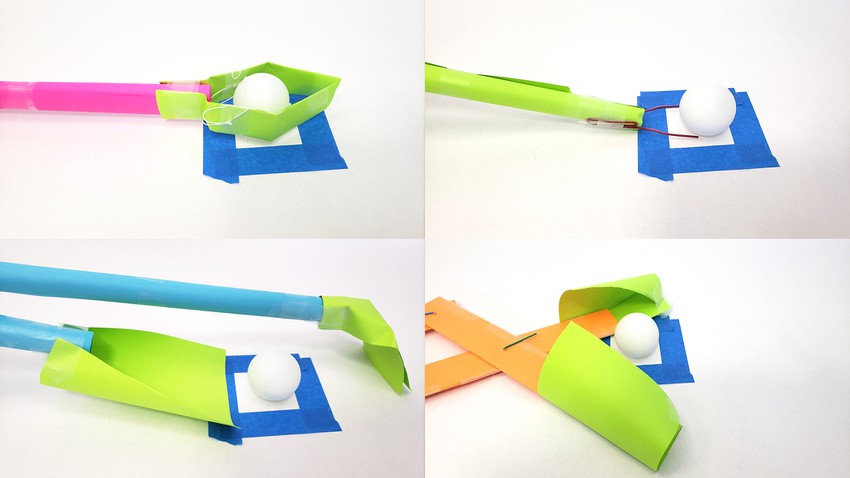 four different grabber designs in the process of picking up a ping pong ball.