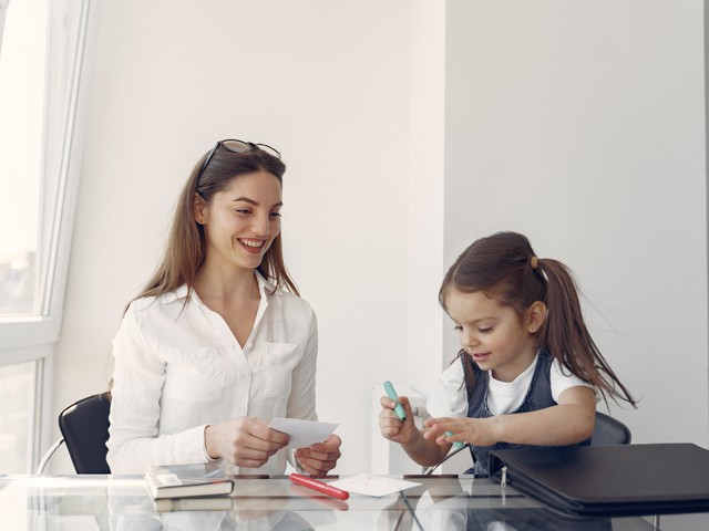 Speech pathologist doing exercise with child